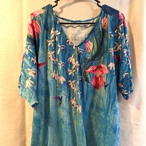Light blue floral silky blouse with short sleeves.
